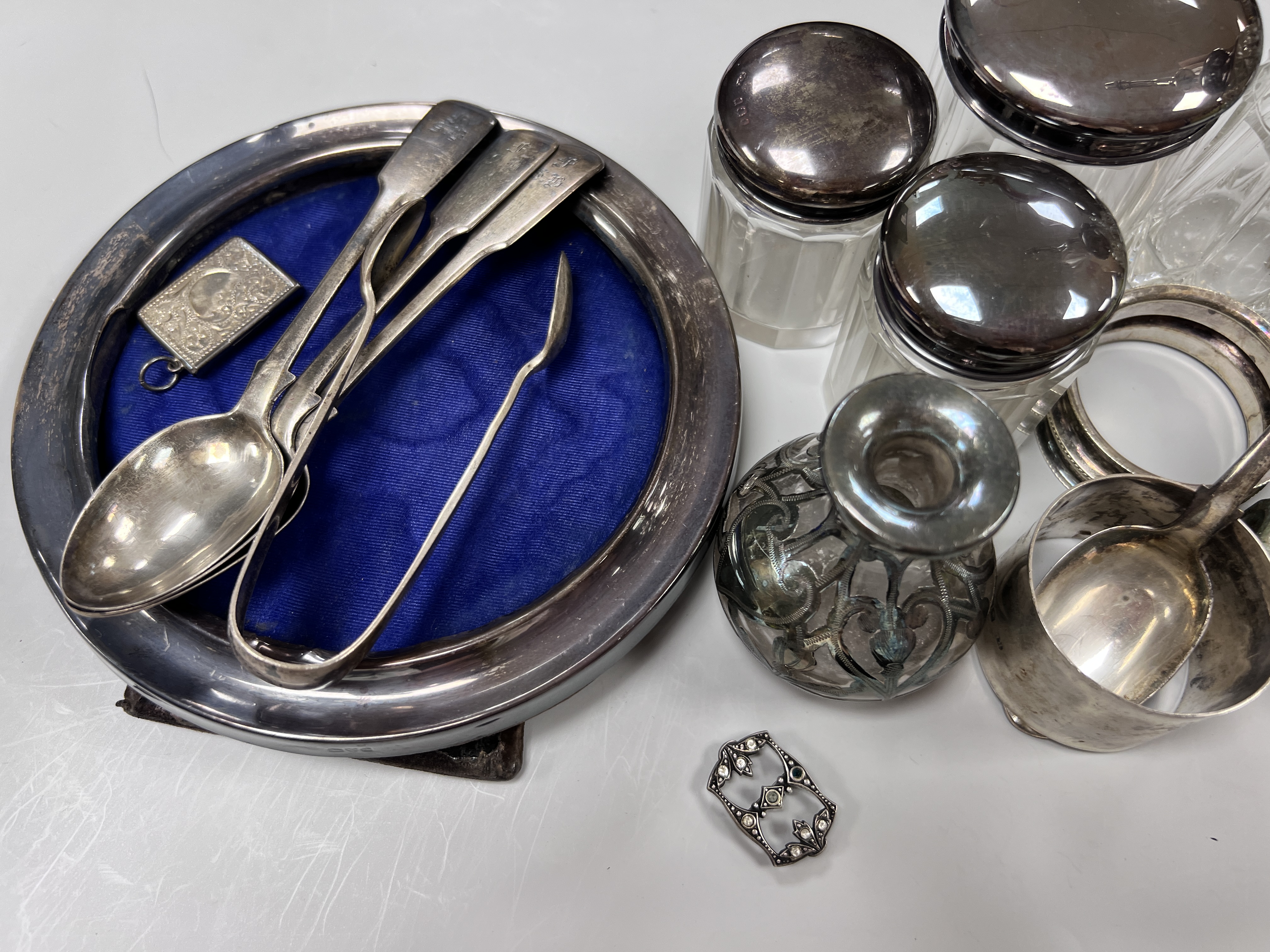 Sundry small silver including circular photograph frame, toilet jars, napkin ring ring tree etc.